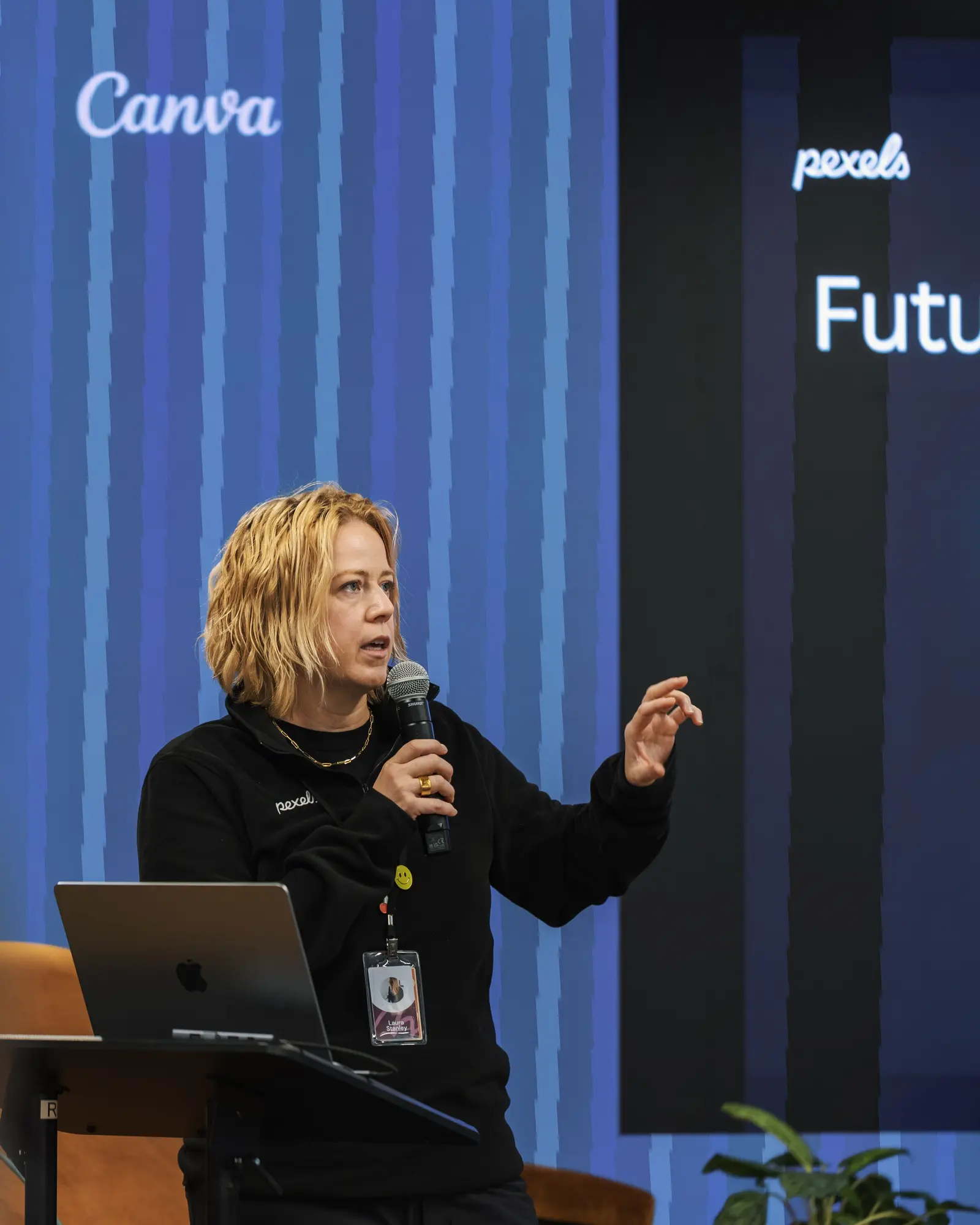 Keynote speaker presenting from a lit stage at a technology conference.