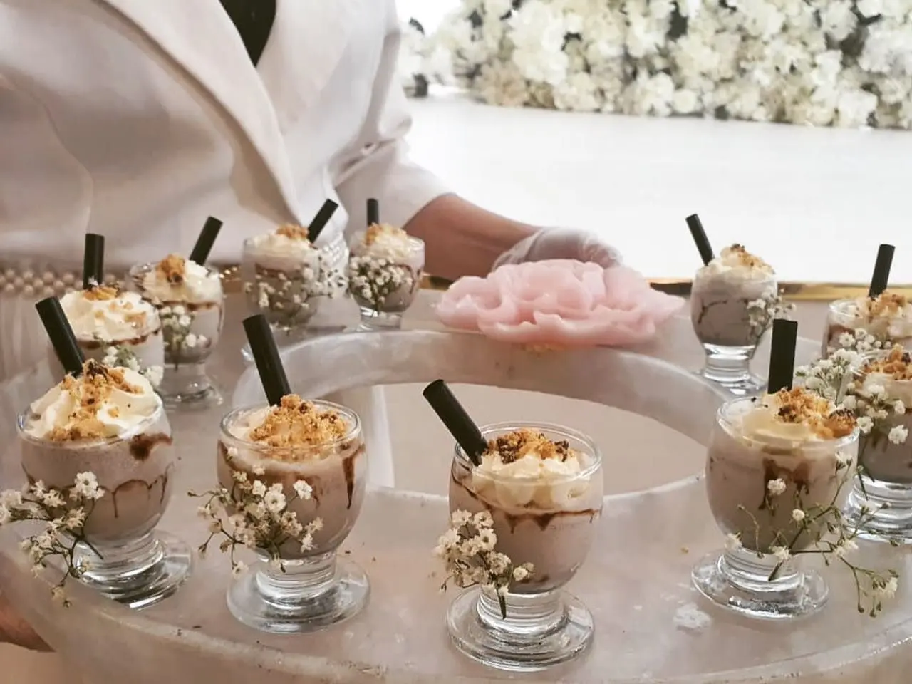 Individual dessert cups arranged for guest service at an event.
