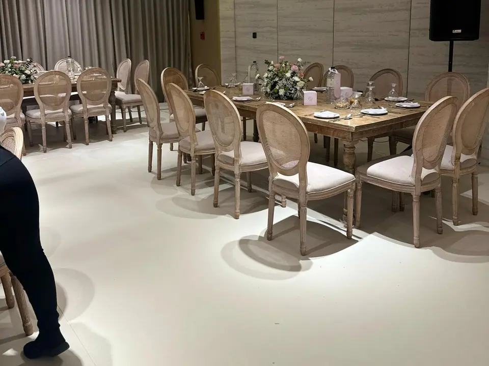 Formal event dining room prepared with round tables and guest seating.
